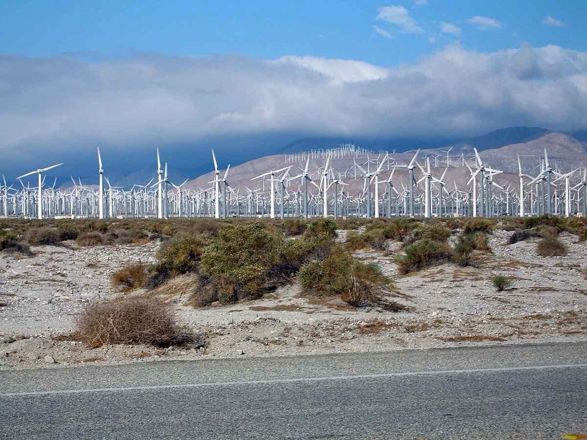 Rows of wind turbines at wind farm at hills